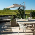 Stadstuin in Nijmegen Noord. Met prachtig uitzicht over het landschap. Opentuin met verschillende terrassen. Groene oase. Keramisch terras, grind en vlonderpad. Postzegeltuin aan het landschap met uitzicht op de dijk van de Waalbrug.