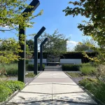 Zichtlijn door de groene Designtuin met veel weelderige beplanting met solitaire heesters, Strakke tuinelementen met Erik van Gelder Designtegels in prachtige groene beplanting. Uitgebreid verlichtingsplan met designverlichting als tuinelementen. Loungeplek met groot terras als heerlijke zithoek in de zon. Tuinontwerp en Tuinaanleg door Uw Tuin hoveniers uit Malden.