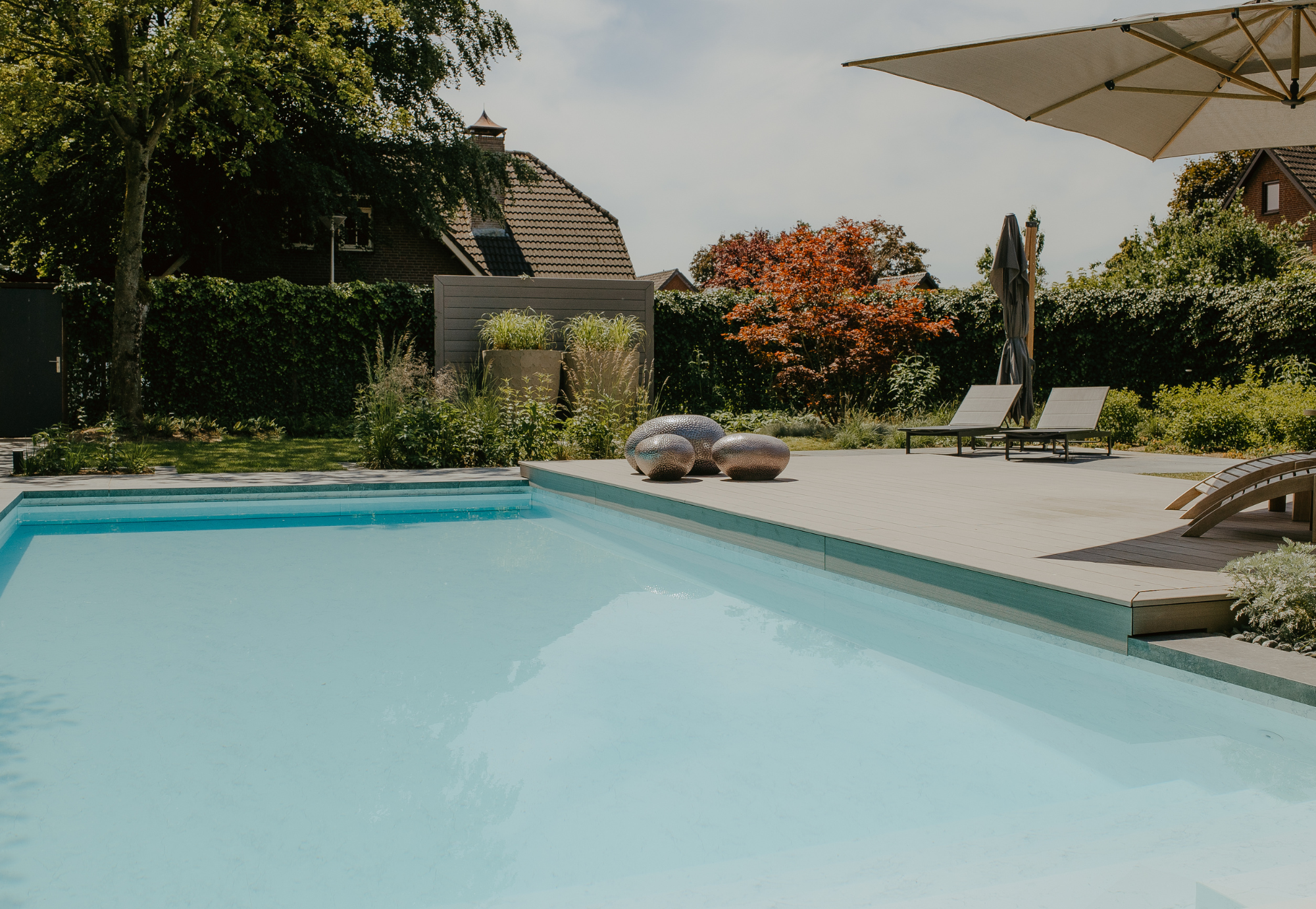 Luxe zwembad in het groen. Hoogwaardige vlonder en materialen. Tuinaanleg door uw Tuin hoveniers uit Nijmegen. Hovenier boxmeer.