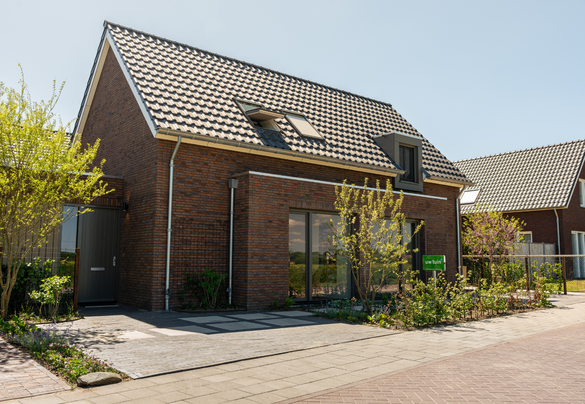 Groene Voortuin nieuwbouwwoning in Overasselt. Tuinaanleg door Uw Tuin hoveniers.